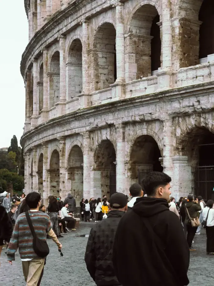 The crowd walking past the Colosseum